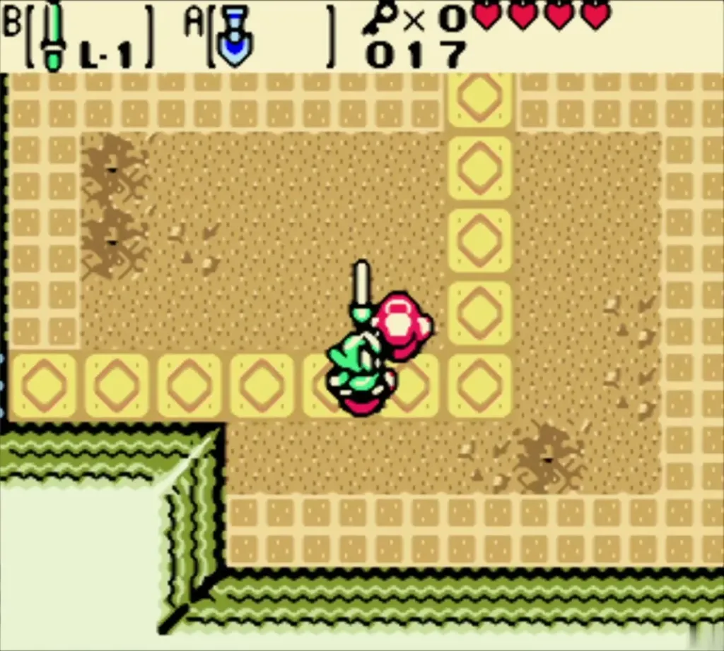 Link slashing a Gel on the yellow-tile floor, key counter at 0 Link slashing a Gel on the yellow-tile floor, key counter at 0