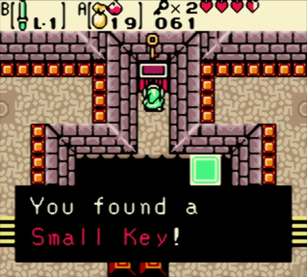 Link holding up a Small Key with the key counter at 2 and the item message Link holding up a Small Key with the key counter at 2 and the item message