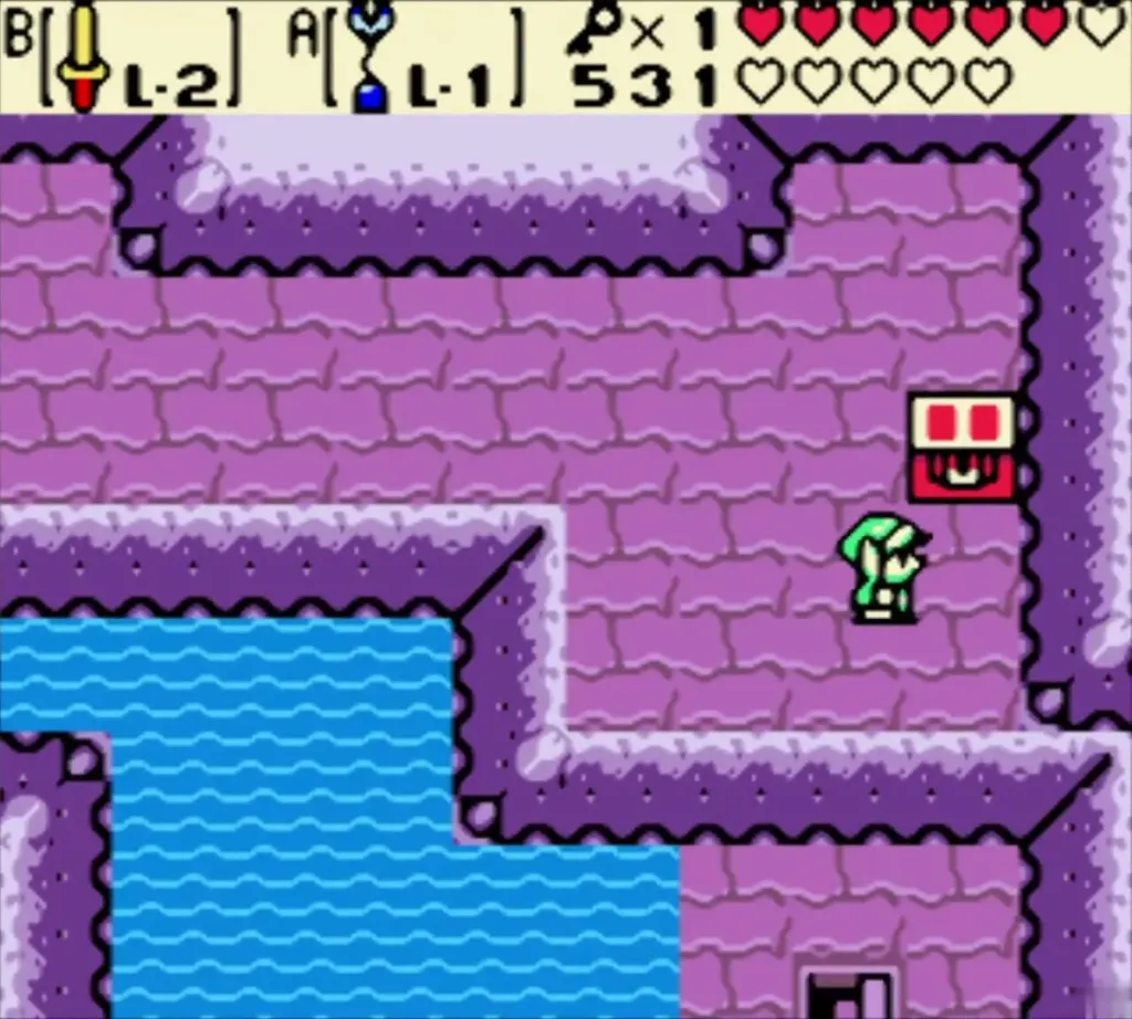 Link on a purple ledge beside a chest above the water in the dungeon Link on a purple ledge beside a chest above the water in the dungeon