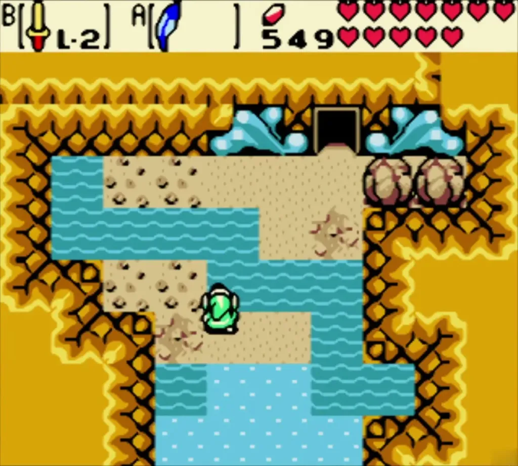 Link beside the blue pool at the cave entrance, with the dark doorway above in the cliff Link beside the blue pool at the cave entrance, with the dark doorway above in the cliff
