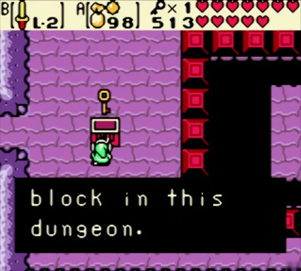 Link holding up a Small Key by the red-block chest, with the box ending in block in this dungeon Link holding up a Small Key by the red-block chest, with the box ending in block in this dungeon