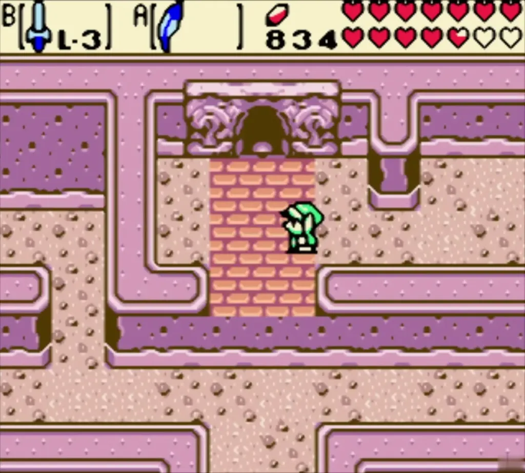 Link walking up to the pink-brick doorway of the Ancient Tomb Link walking up to the pink-brick doorway of the Ancient Tomb