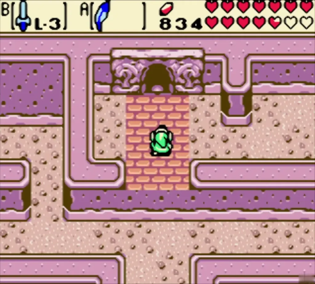 Link on the pink-brick step beneath the stone eye statues of the Ancient Tomb Link on the pink-brick step beneath the stone eye statues of the Ancient Tomb