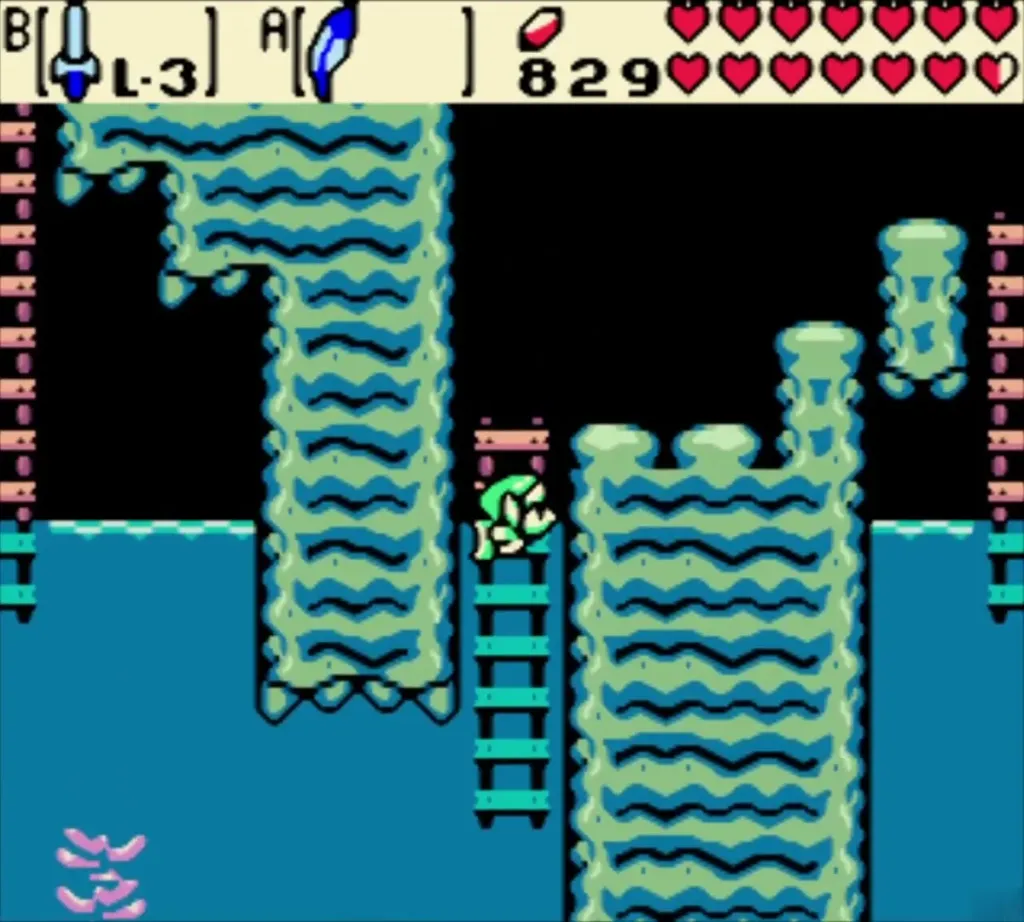 Link above a teal water room with ladders between stone pillars Link above a teal water room with ladders between stone pillars