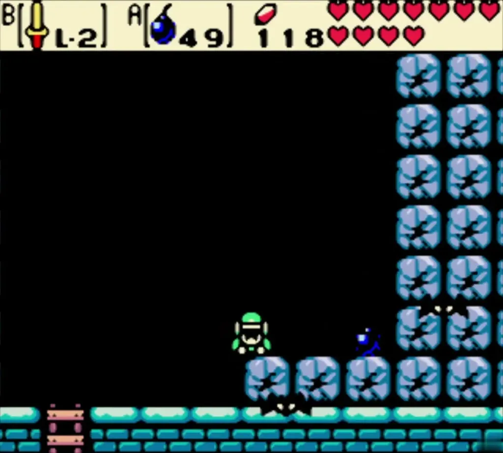Link on the cracked blue blocks beside a lit Bomb Link on the cracked blue blocks beside a lit Bomb