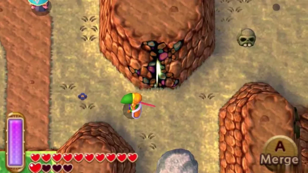 Link on a brown canyon path below a Fissure in the cliff, a skull beside it and large grey rocks ahead Link on a brown canyon path below a Fissure in the cliff, a skull beside it and large grey rocks ahead