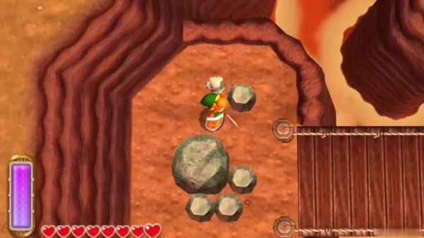 Link beside a large grey boulder and small stones in a Lorule Death Mountain stone field