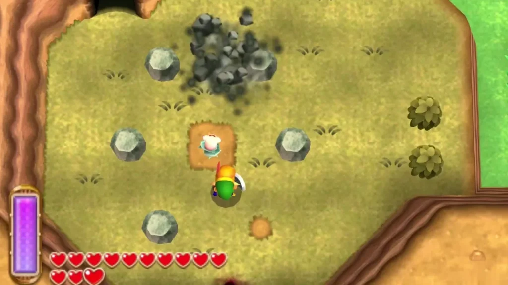 Link on olive ground beside a ring of four small grey rocks around a dug patch, a lost Maiamai on the patch Link on olive ground beside a ring of four small grey rocks around a dug patch, a lost Maiamai on the patch