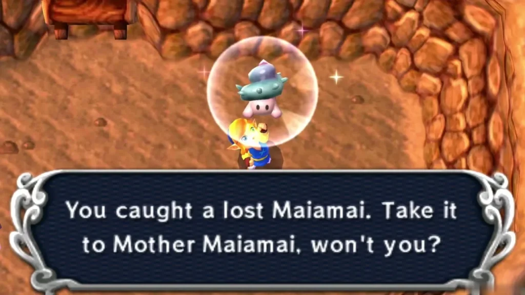 Link holding up a caught lost Maiamai in a bubble on a dirt floor beside a stone wall, the catch message complete Link holding up a caught lost Maiamai in a bubble on a dirt floor beside a stone wall, the catch message complete