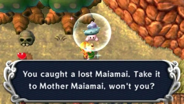 Link holding up a caught lost Maiamai in a bubble in the Lorule Graveyard, beside a skull and an orange rock cliff