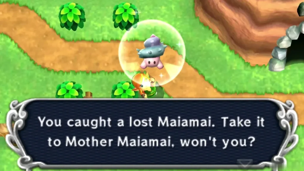Link holding up a caught lost Maiamai in a bubble on grass beside a cave in a brown cliff, the catch message complete Link holding up a caught lost Maiamai in a bubble on grass beside a cave in a brown cliff, the catch message complete