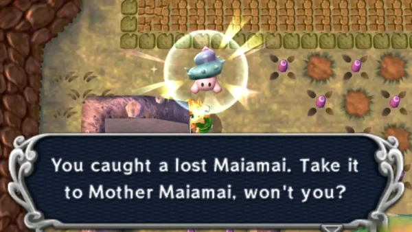 Link catching a lost Maiamai beside a low stone structure in Thieves' Town, the catch message on screen Link catching a lost Maiamai beside a low stone structure in Thieves' Town, the catch message on screen