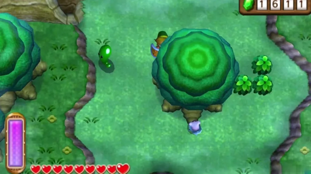 A lost Maiamai dropping out beneath a round green tree in the Lost Woods after Link's dash, with green blobs nearby A lost Maiamai dropping out beneath a round green tree in the Lost Woods after Link's dash, with green blobs nearby