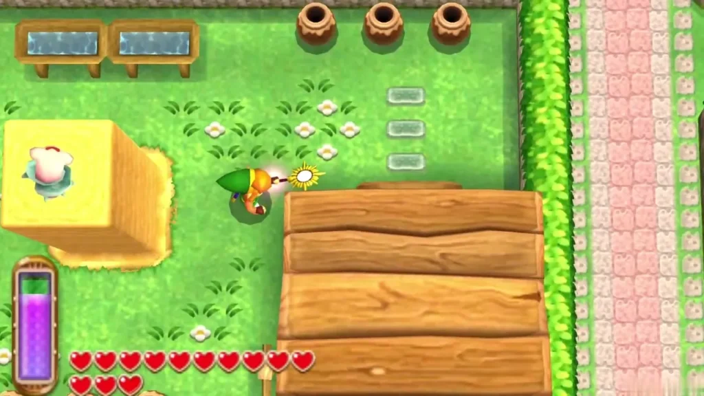 Link with his sword drawn beside a raised sand pillar with a lost Maiamai on top, in a Kakariko back garden Link with his sword drawn beside a raised sand pillar with a lost Maiamai on top, in a Kakariko back garden