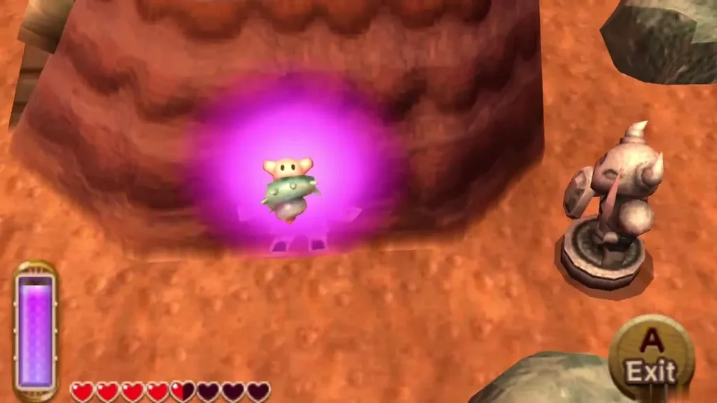 A lost Maiamai glowing pink against a red cliff wall on Death Mountain beside a stone statue, with the Exit prompt showing A lost Maiamai glowing pink against a red cliff wall on Death Mountain beside a stone statue, with the Exit prompt showing