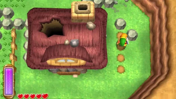 The Miner's House, a rock-walled building with grey boulders scattered around it on the grass