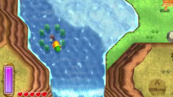 Link swimming in the river beside a ring of green rupees underwater, with the Dive prompt on screen