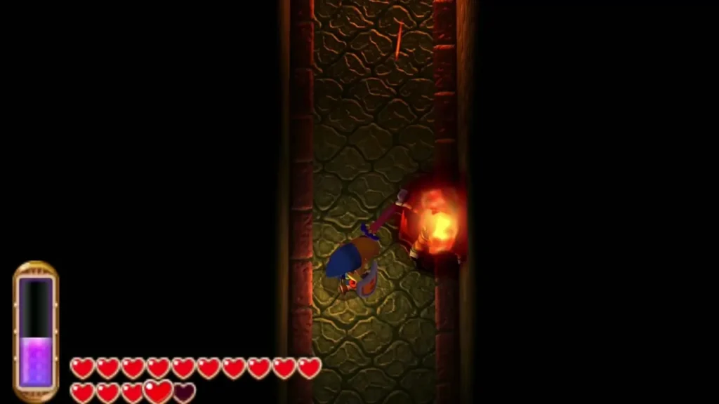 Link attacking a Gibdo with fire in the narrow Skull Woods corridor Link attacking a Gibdo with fire in the narrow Skull Woods corridor