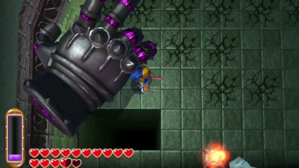 Knucklemaster metal hand looming over Link at the edge of a floor pit Knucklemaster metal hand looming over Link at the edge of a floor pit