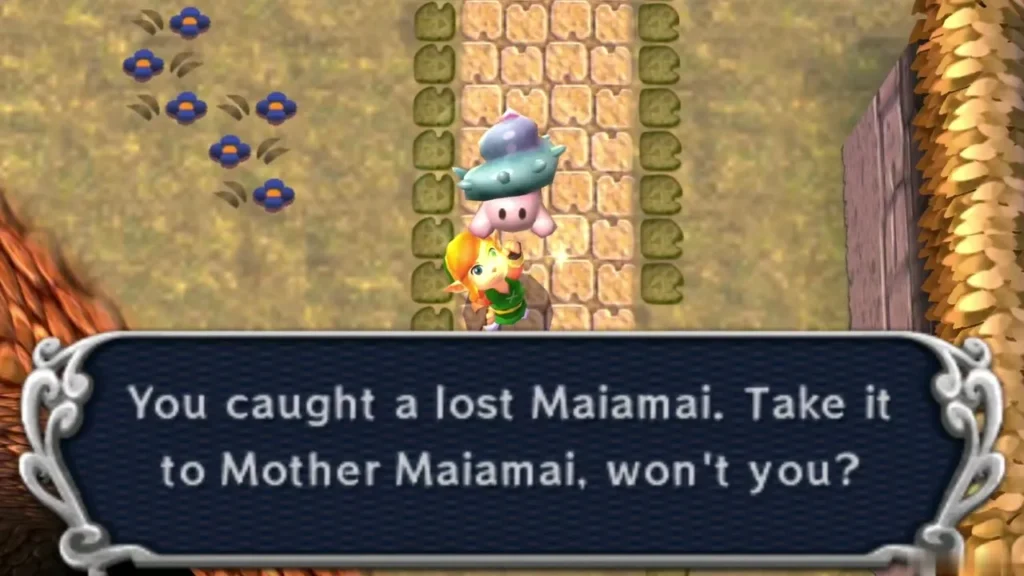 Link holds up a lost Maiamai beside a hedge row and blue flowers, with the catch message complete Link holds up a lost Maiamai beside a hedge row and blue flowers, with the catch message complete