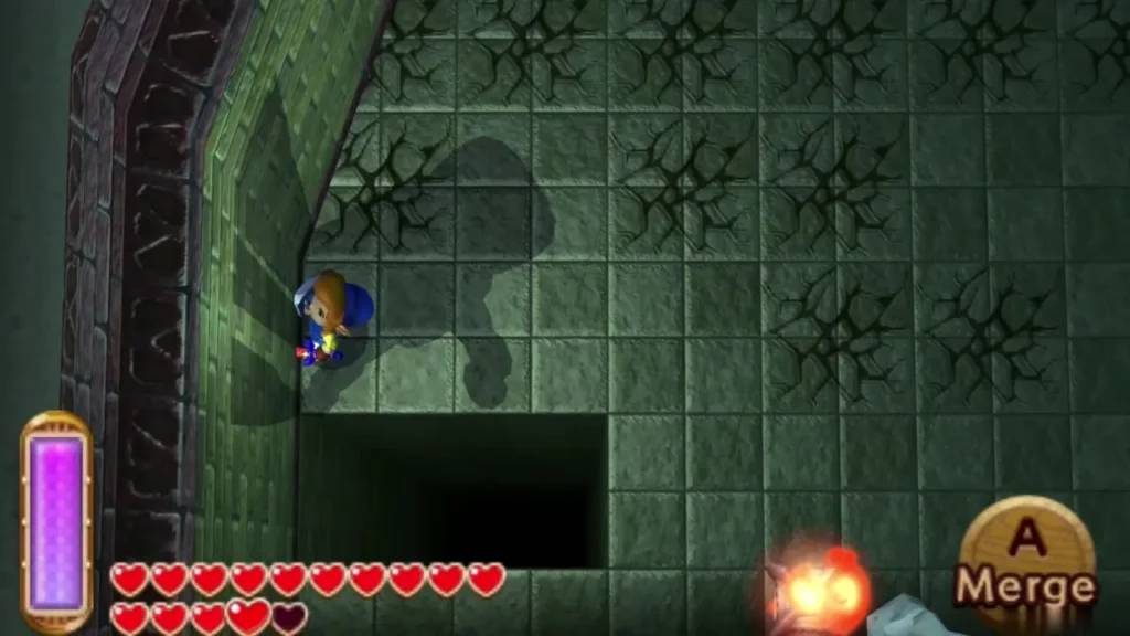 Link beside the wall at the edge of a dark pit with the Merge prompt showing Link beside the wall at the edge of a dark pit with the Merge prompt showing