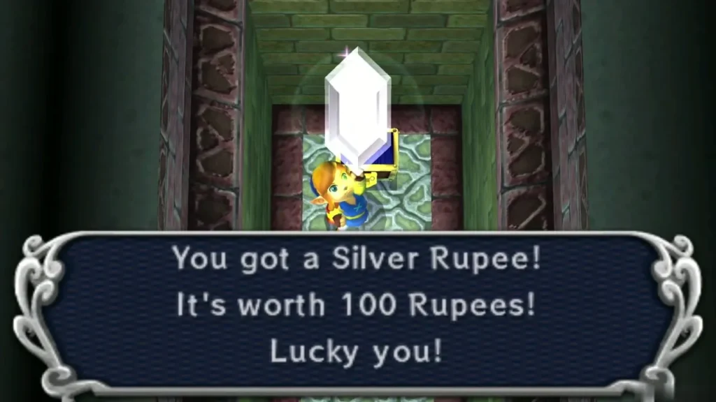 Link holding up a Silver Rupee, with the message box saying it is worth 100 Rupees Link holding up a Silver Rupee, with the message box saying it is worth 100 Rupees