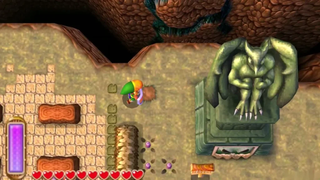 A green gargoyle statue looms over a courtyard in Thieves' Town as Link approaches A green gargoyle statue looms over a courtyard in Thieves' Town as Link approaches