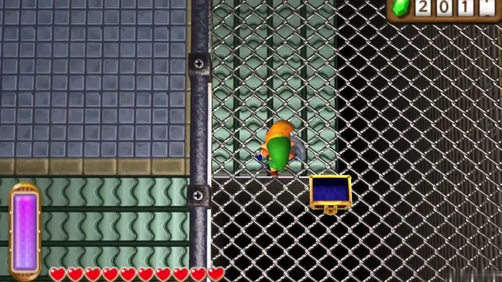 Link beside a gold chest behind iron mesh in a Thieves' Hideout cell Link beside a gold chest behind iron mesh in a Thieves' Hideout cell