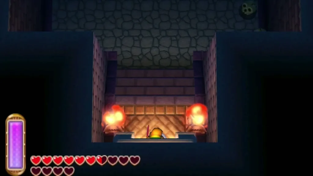 Link at the foot of the Swamp Palace entrance stairs, flanked by two lit torches Link at the foot of the Swamp Palace entrance stairs, flanked by two lit torches
