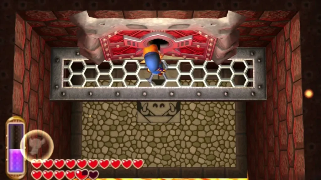 Link standing below the huge red boss door behind a metal grate Link standing below the huge red boss door behind a metal grate