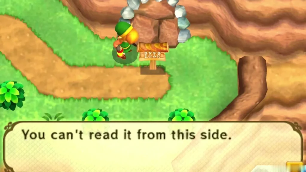Link beside the sign in front of the rock-blocked cave, its box saying you can't read it from this side Link beside the sign in front of the rock-blocked cave, its box saying you can't read it from this side