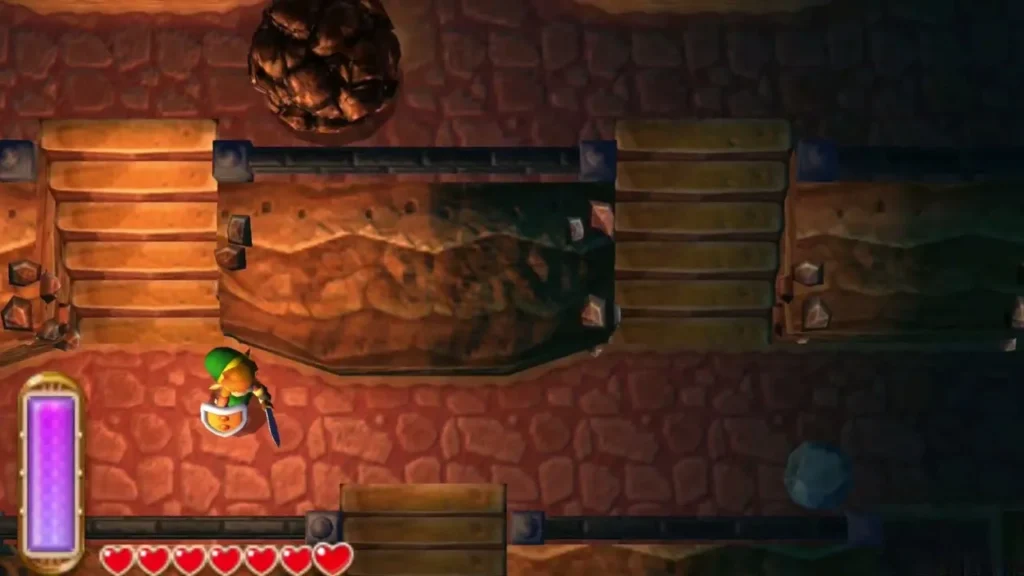 A boulder rolling along the ledge above the cave stairs as Link waits below A boulder rolling along the ledge above the cave stairs as Link waits below