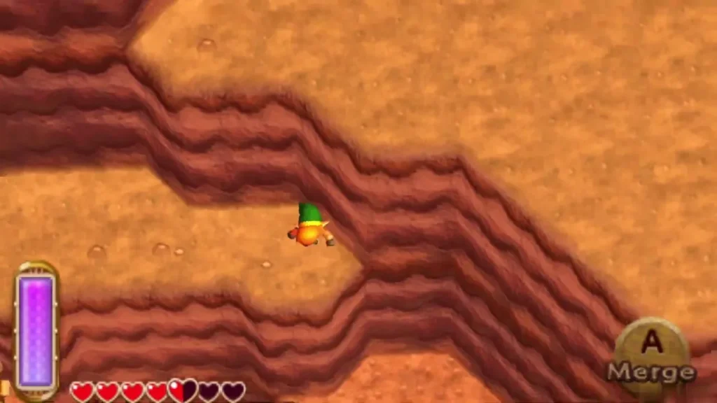 Link on a narrow cliff path between red walls with the Merge prompt on screen Link on a narrow cliff path between red walls with the Merge prompt on screen