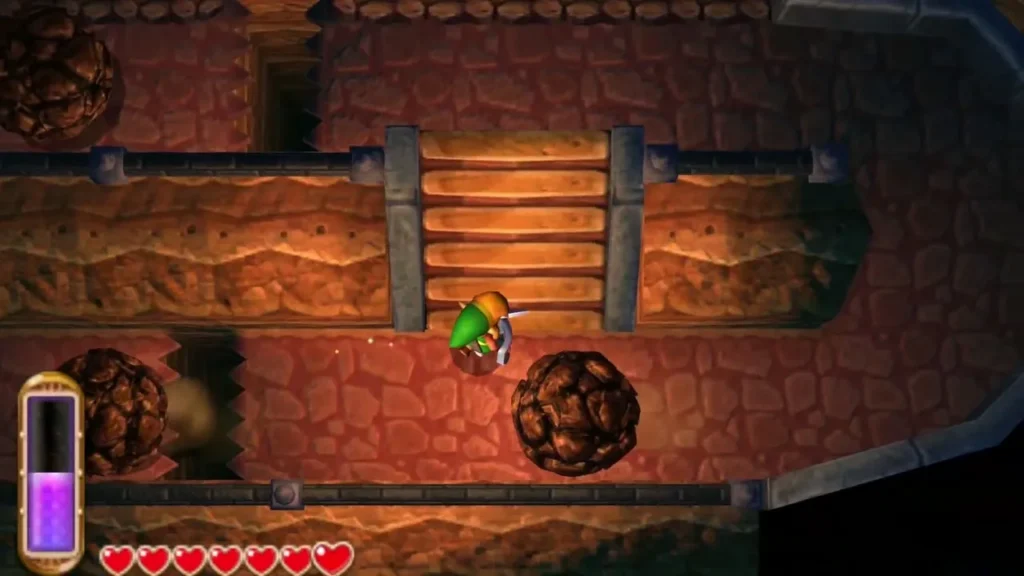 Link at the foot of the cave stairs with a boulder rolling beside him Link at the foot of the cave stairs with a boulder rolling beside him