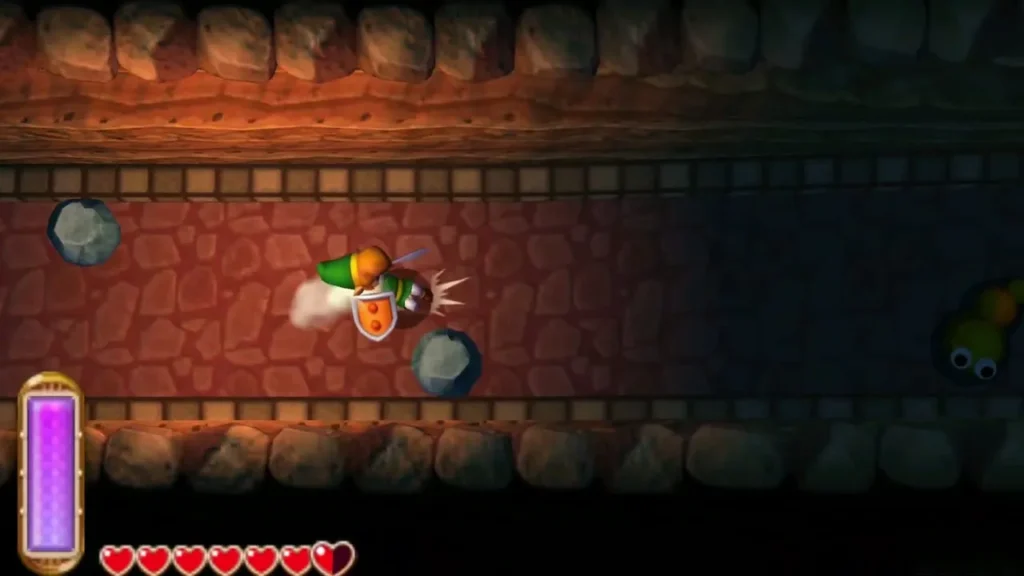 Link slashing at a Mini-Moldorm in the winding stone tunnel under Death Mountain Link slashing at a Mini-Moldorm in the winding stone tunnel under Death Mountain