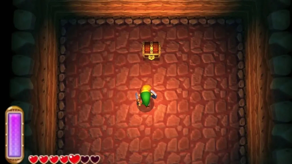 Link in the second red-rock side cave, walking toward the chest at the top of the room Link in the second red-rock side cave, walking toward the chest at the top of the room