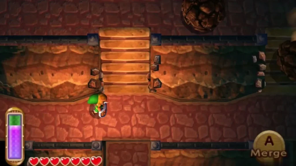 Link at the foot of the second cave stairs, boulders lining the steps and a Merge prompt on screen Link at the foot of the second cave stairs, boulders lining the steps and a Merge prompt on screen