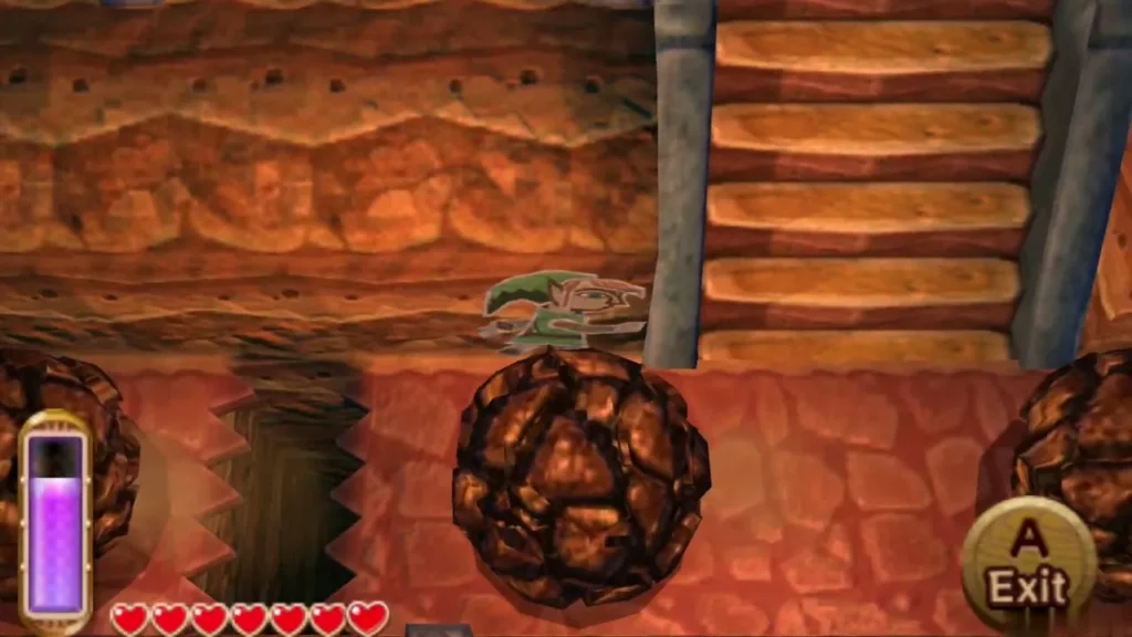 Link merged into the cave wall beside the stairs as a boulder rolls past Link merged into the cave wall beside the stairs as a boulder rolls past