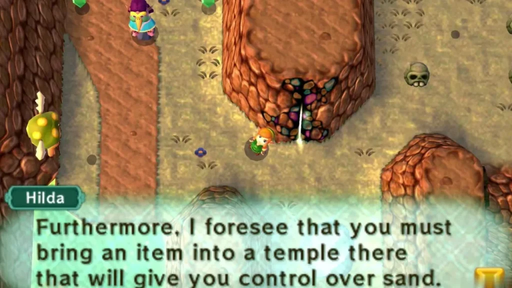 Hilda's text box beside a cave entrance in the sandy desert, with skull rocks nearby