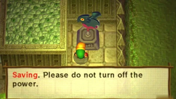 Link beside a dark-bird weather vane on a stone pedestal in Lorule, a Saving message box across the bottom