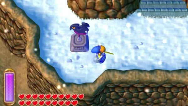 Link beside a dark bird weather vane on a snowy path, with stone stairs at the top right of the frame