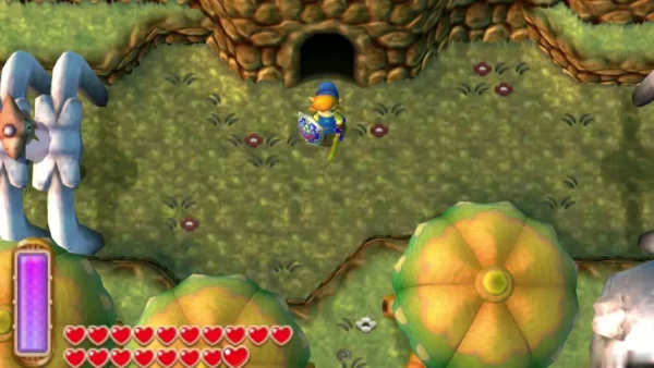 Link in the grass below a cave mouth in the rocky wall, shield and sword ready