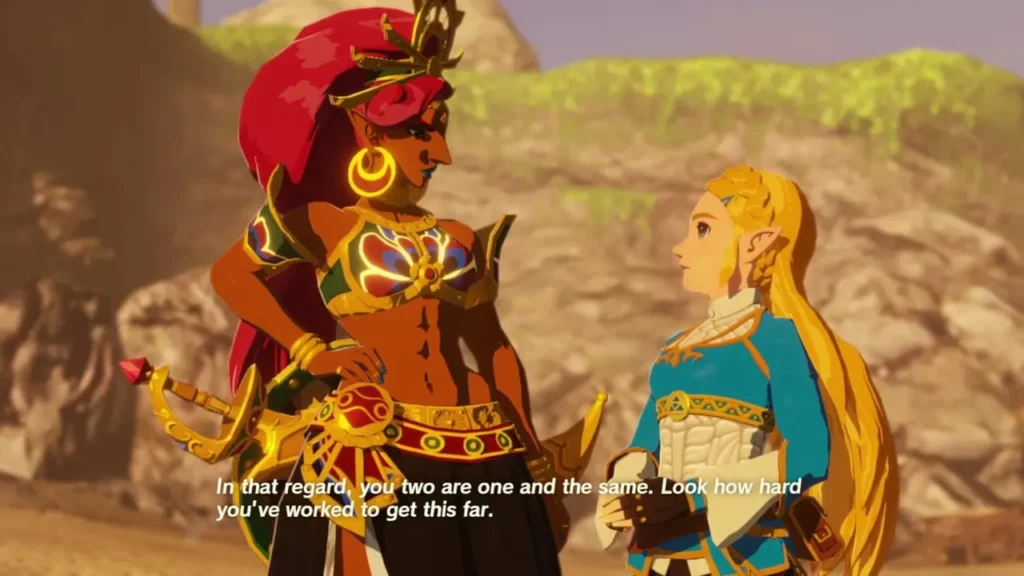 Urbosa, the Gerudo Chief, speaks with Zelda on a sandy rocky path