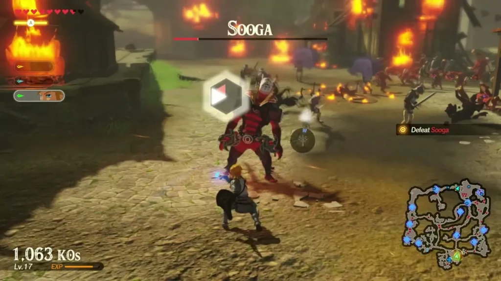 Sooga stands in a burning village with a lock-on marker over him and the Defeat Sooga objective on screen Sooga stands in a burning village with a lock-on marker over him and the Defeat Sooga objective on screen