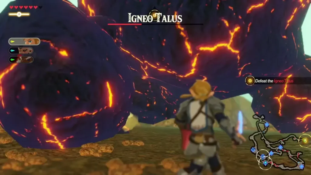 An Igneo Talus takes its name card at the top of the screen as the Defeat the Igneo Talus objective appears