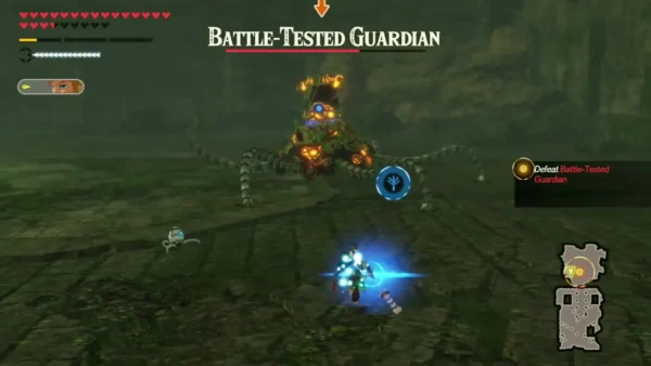 A blue lock-on reticle hovers over the Battle-Tested Guardian in a stone chamber while Link stands ready