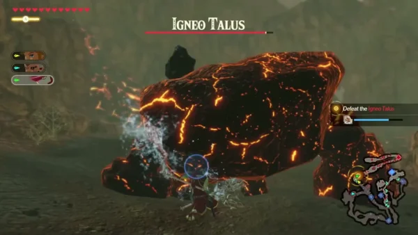 Link hits an Igneo Talus with a blue ice attack while its name bar and objective show