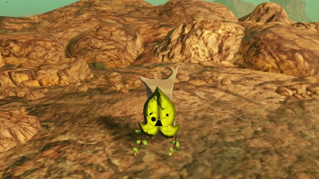 A yellow Korok stands in front of a rock wall on the path past the wooden bridge A yellow Korok stands in front of a rock wall on the path past the wooden bridge