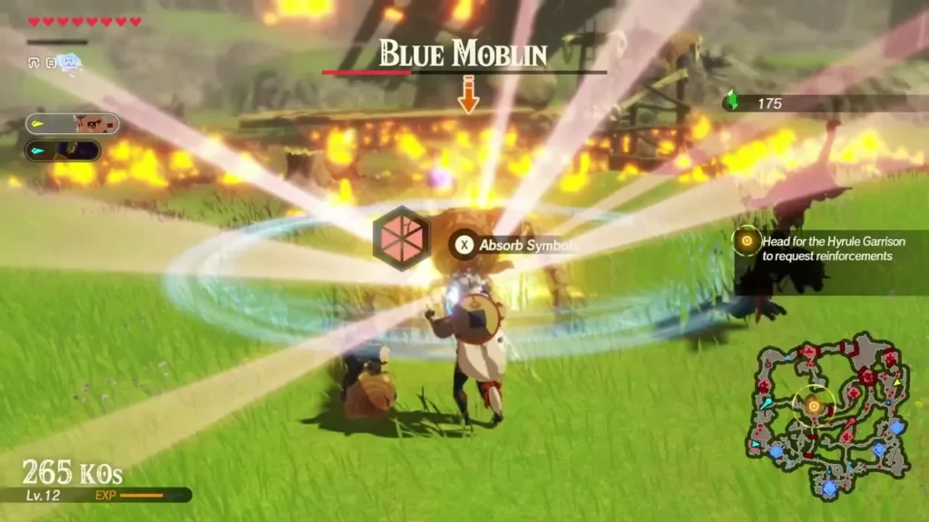 A Blue Moblin fights in a field of fire with the Absorb Symbols prompt on screen A Blue Moblin fights in a field of fire with the Absorb Symbols prompt on screen