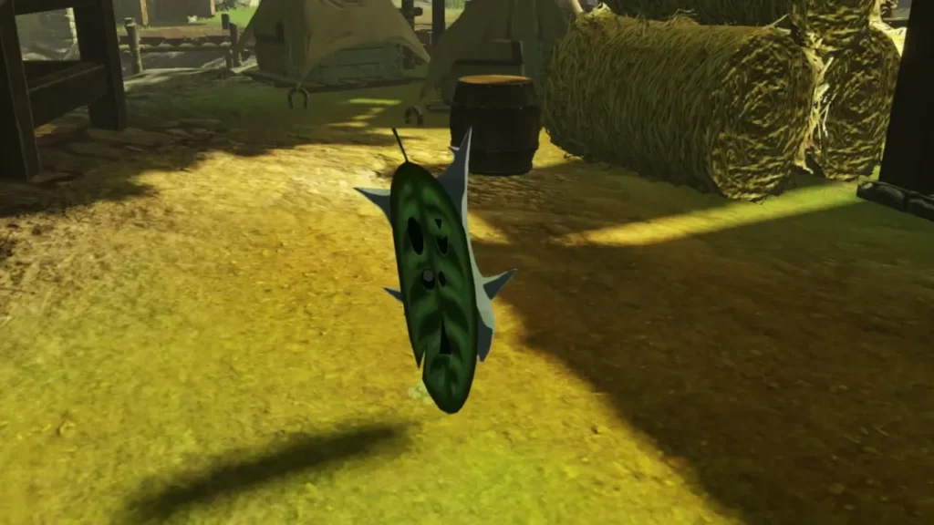 Green leaf-faced Korok on the ground beside hay bales and barrels in the village Green leaf-faced Korok on the ground beside hay bales and barrels in the village